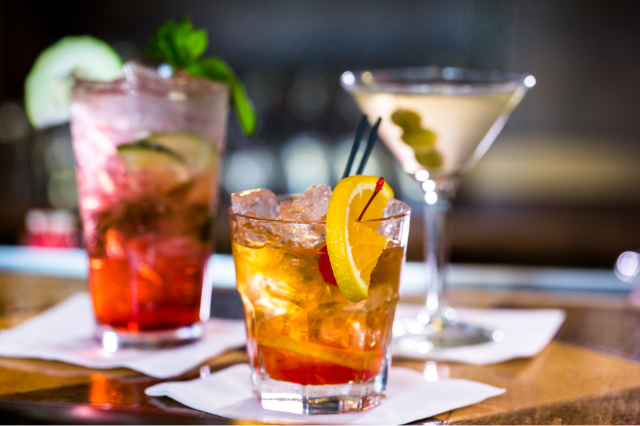 three cocktails on napkins 