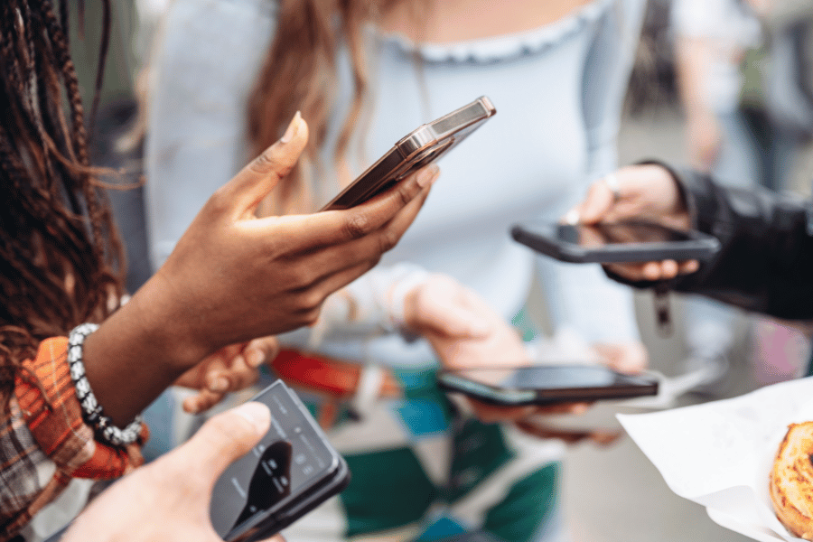 group of friends on their phones and using social media
