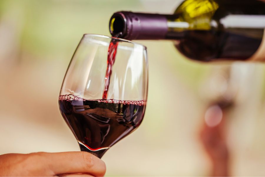 Pouring red wine into wine glass