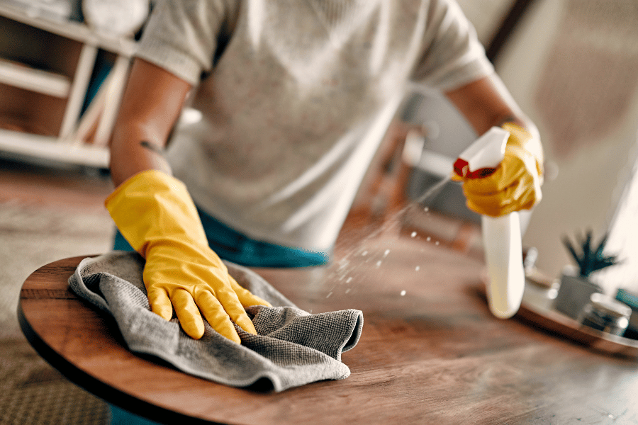 homeowner cleaning new home and wiping down new surfaces
