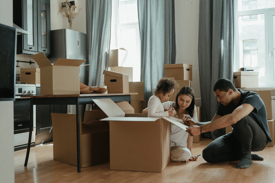 family of three packing up kitchen and preparing for a move