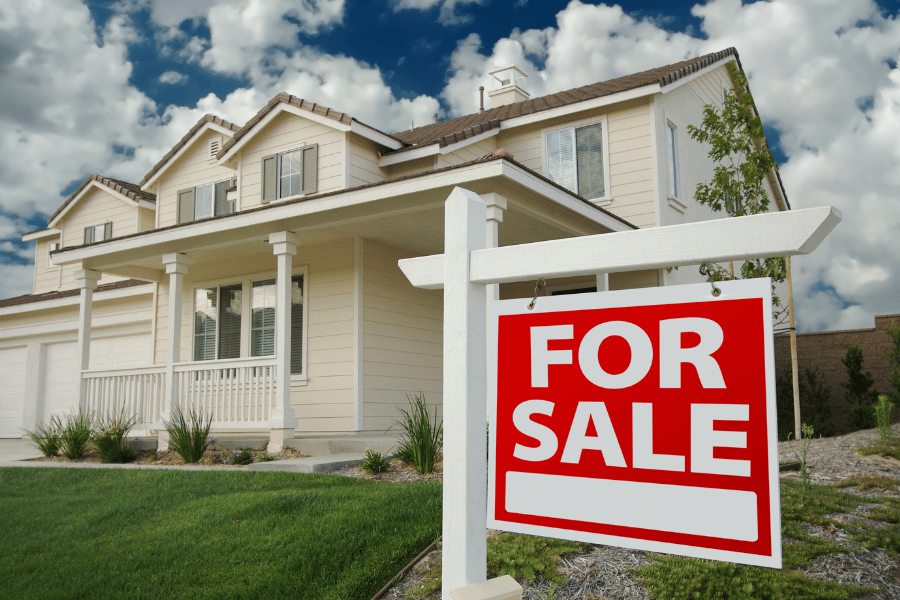 beautiful home for sale with sign in the front yard