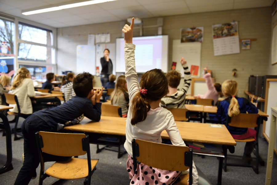 kids in classroom learning and answering questions