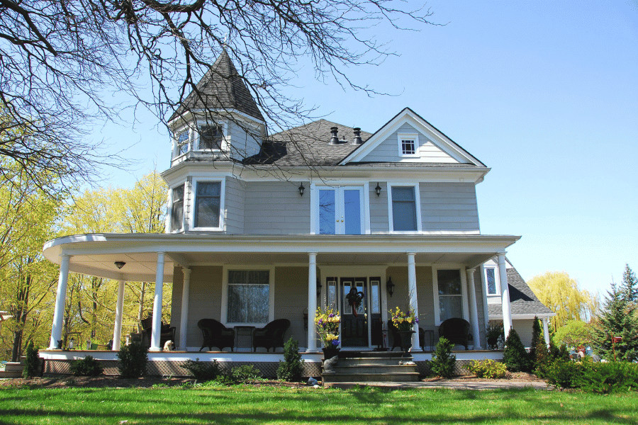 Historical Victorian home with wide front porch sitting on lots of land