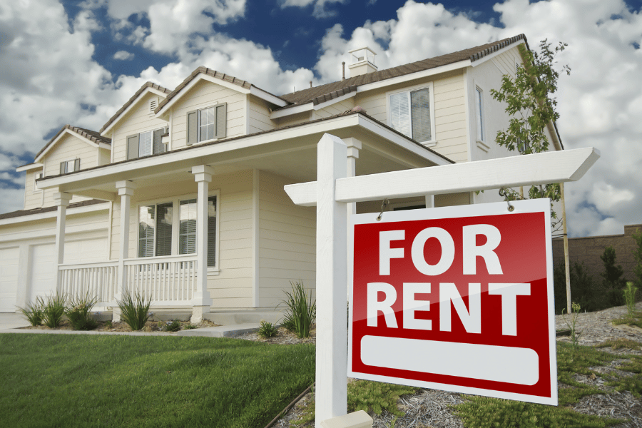 red for rent sign in front of home with front porch