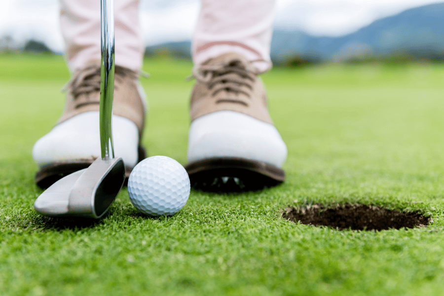 Playing golf with brand new shoes on the green 