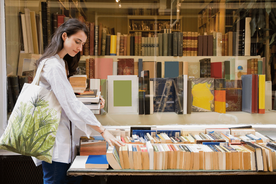 woman browsing for a new book in a bookstore 