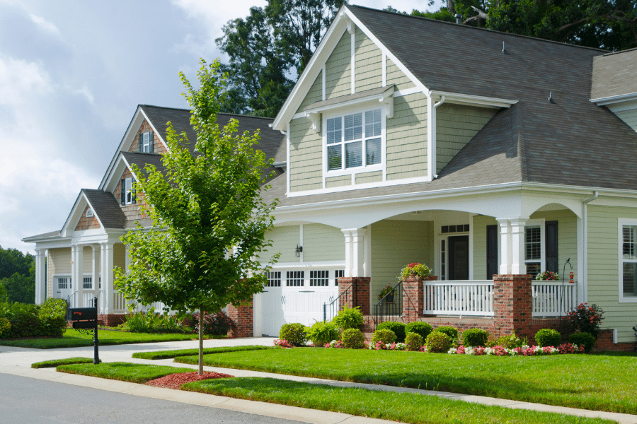 Beautiful homes in a suburban neighborhood with blue skies and freshly cut grass