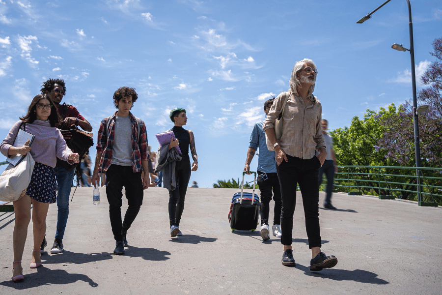 College students walking campus with professor