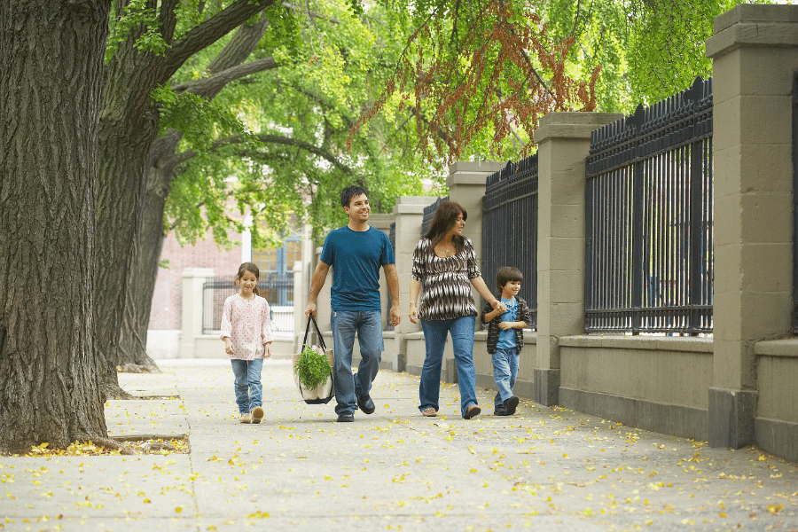 family walking on sidewalk in a safe neighborhood