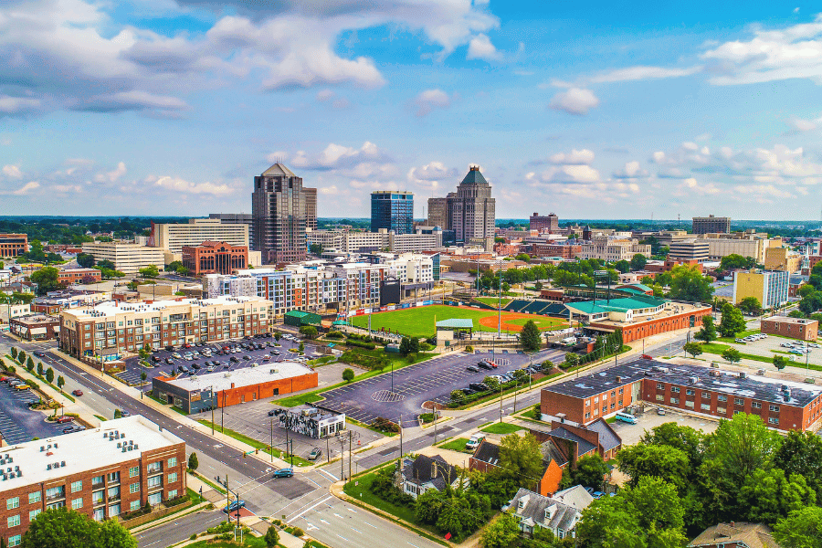 Greensboro, NC skyline with buildings and green spaces