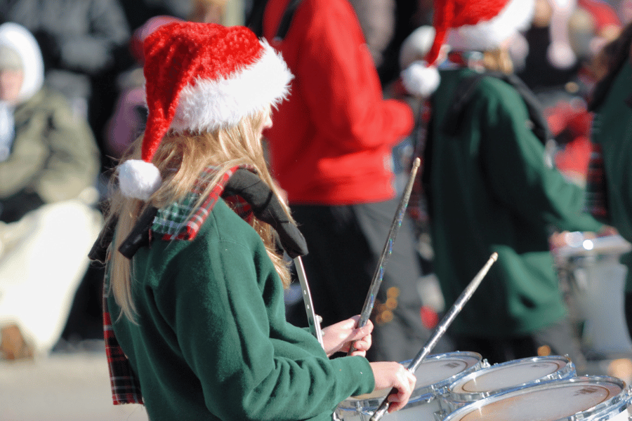 drum line wearing santa hats in a Christmas parade