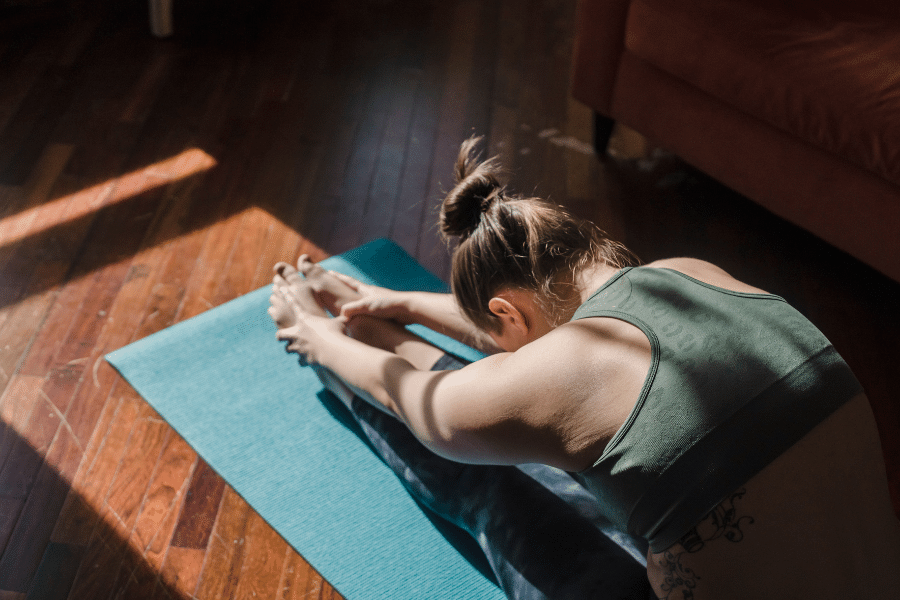 doing yoga on yoga mat in a room