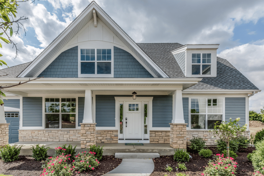 beautiful blue home with front porch and white front door