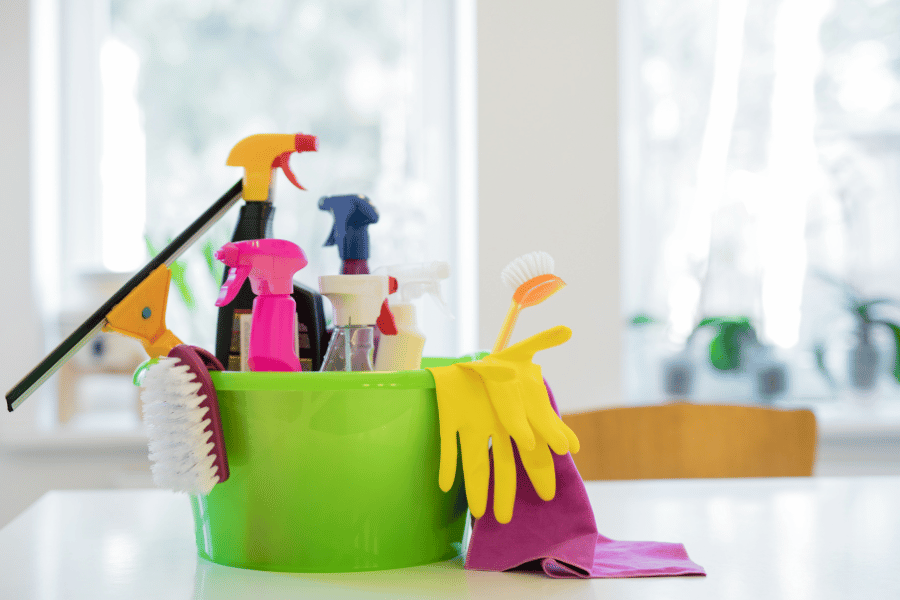 Essential cleaning supplies in a bucket