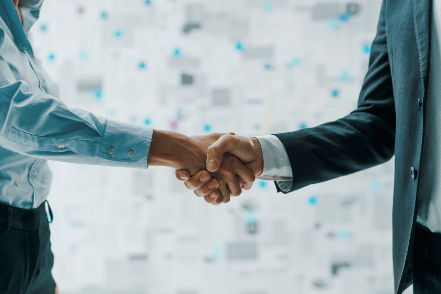two adults shaking hands and meeting each other 