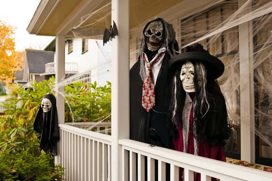 Halloween mannequins and scary decorations on a front porch 