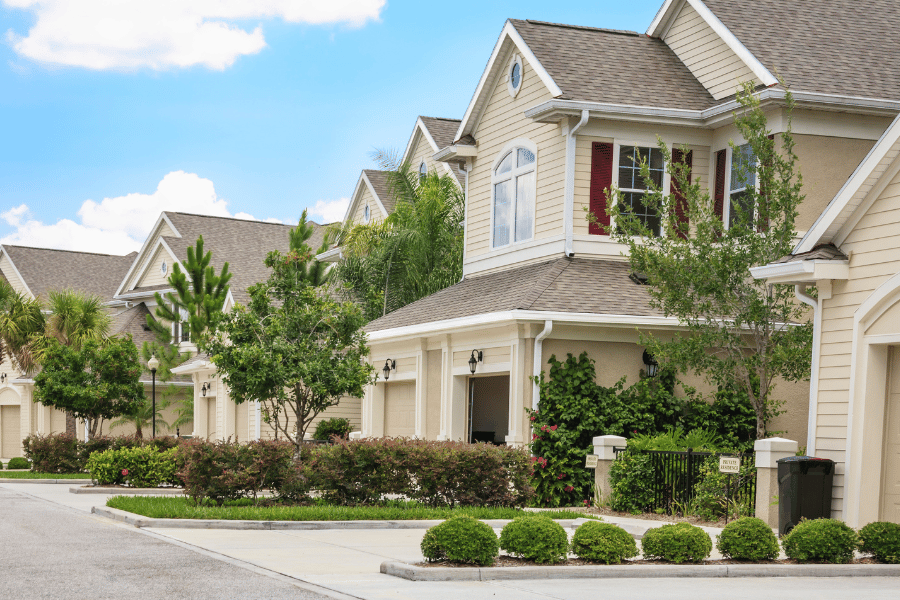 Homes in neighborhoods with trees aligned on street