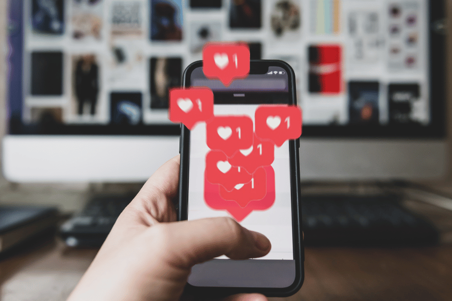 person on the phone receiving social media likes and notifications
