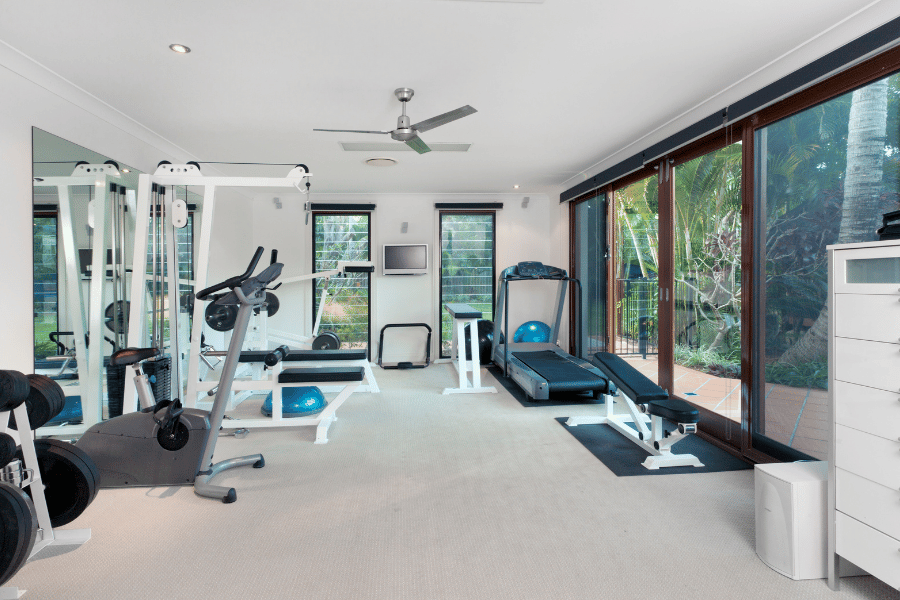 Luxury at home gym built in with appliances throughout the room