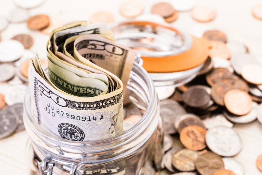 saving money and collecting extra cash in a jar 