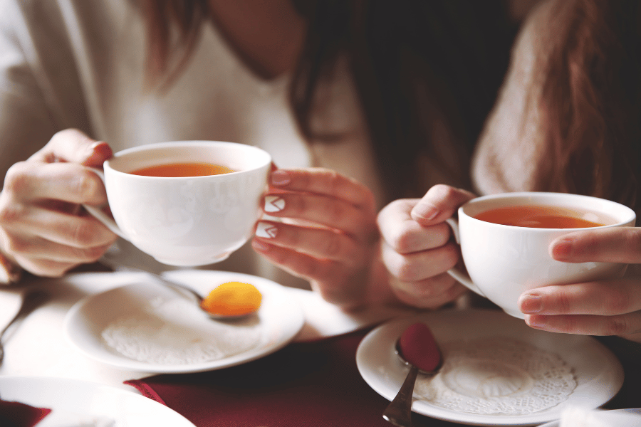 Two friends enjoying a cup of tea together