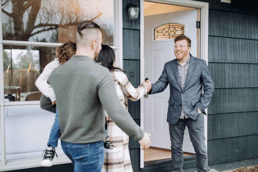 Family meeting up with their buyer agent to tour a house