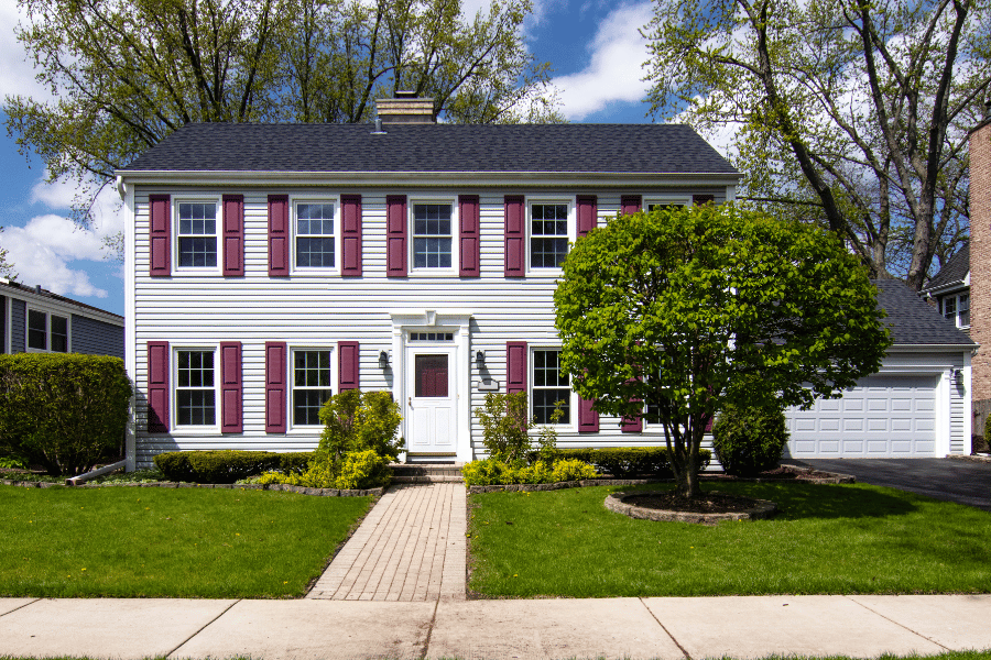 White Saltbox Colonial Style Home with Maroon shutters