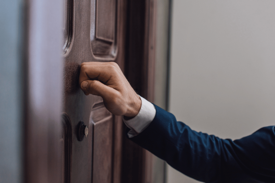 man knocking on a neighbors door that is not for sale 