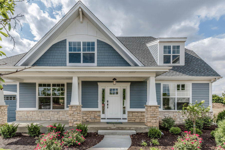 beautiful suburban home with blue siding and front porch