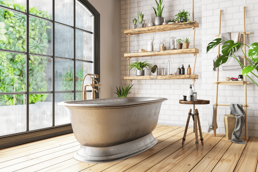Beautiful updated bathroom with a tin bathtub and floor to ceiling windows