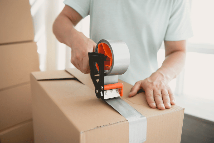homeowner packing boxes full of stuff before moving into new home 