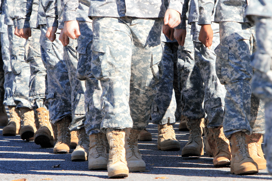 Military members in uniform marching on the street
