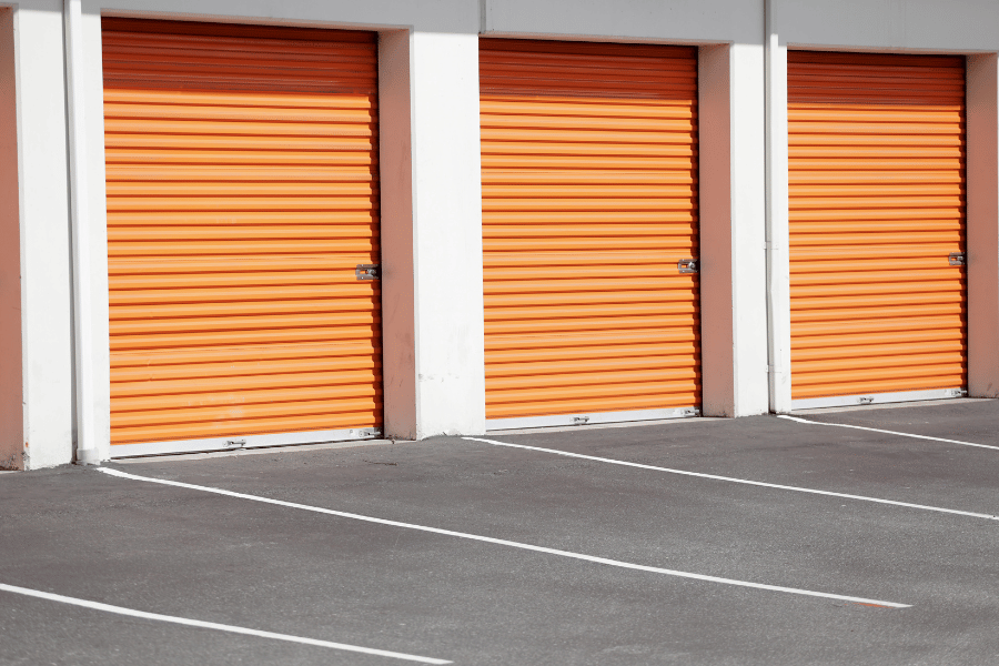 bright orange door storage facility with parking spaces outdoors