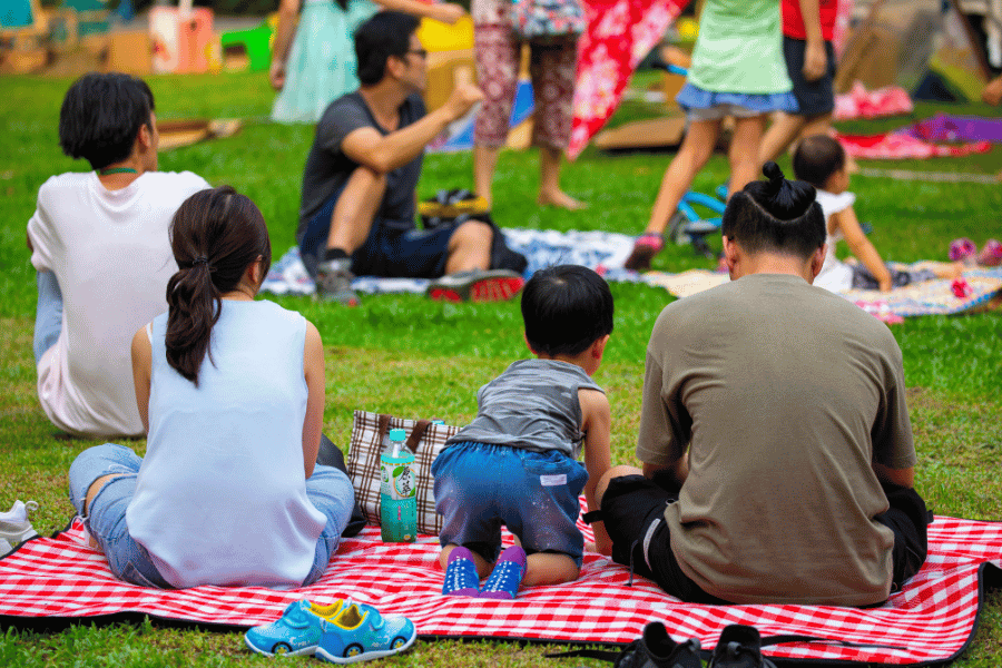 family enjoying a picnic in the park when the weather is nice