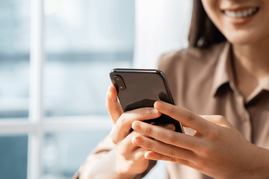 real estate agent on her phone and using social media platforms to generate business 