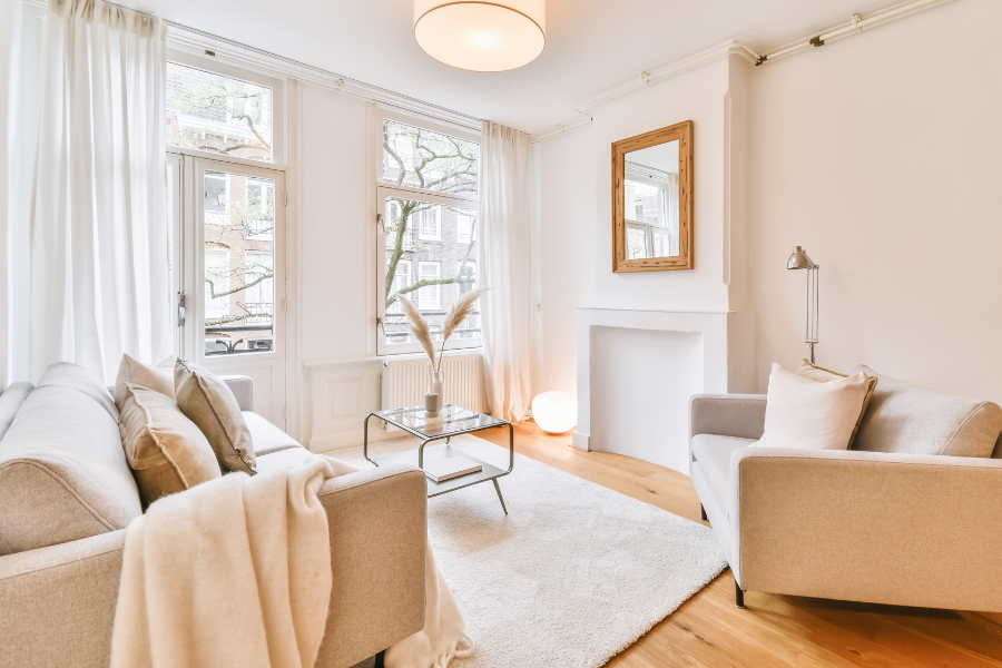Photo of Living Room with Beige Couch, Sheer White Curtains and muted decor