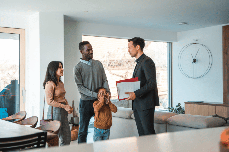 realtor holding an open house an showing around a family that is interested in buying