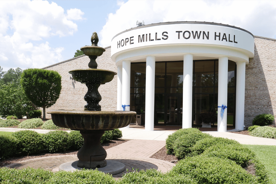 hope mills town hall with fountain on a beautiful day